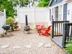 a backyard with a fire pit and a grill at Cottage 10 - 1 Bedroom w/ Loft / 1 Bath in Wolfeboro