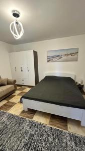 a bedroom with a large bed and a couch at GreenHouse in Brca +21 photos