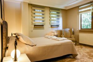a bedroom with a bed and a chair and windows at Boğaz Manzaralı Havuzlu Lüks Villa in Istanbul +36 photos