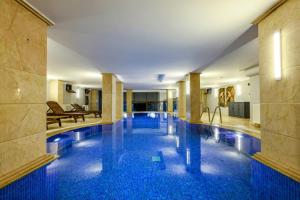 a swimming pool in a hotel with blue tiles at Boğaz Manzaralı Havuzlu Lüks Villa in Istanbul