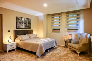 a bedroom with a bed and a chair at Boğaz Manzaralı Havuzlu Lüks Villa in Istanbul