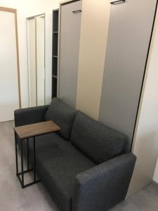 a couch and a table in a room at 6 Next To Paris in Montreuil