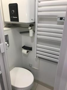 a small bathroom with a toilet and a camera at 6 Next To Paris in Montreuil