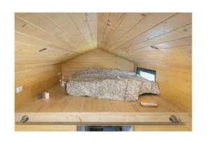 a bed in a small room in a wooden house at l'escale de Normandie in Saint-Martin-au-Bosc +38 photos