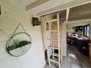 a mirror on the wall of a tiny house at l'escale de Normandie in Saint-Martin-au-Bosc