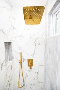 a bathroom with white marble walls and a shower stall at G O G Building in Darby +203 photos