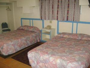 Postel nebo postele na pokoji v ubytování Hotel León