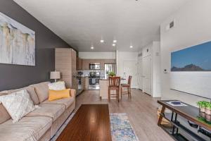 a living room with a couch and a table at 6th floor Luxury Apt - King Bed Pool Prkng Gym NEW in Salt Lake City