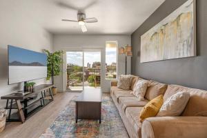 a living room with a couch and a flat screen tv at 6th floor Luxury Apt - King Bed Pool Prkng Gym NEW in Salt Lake City