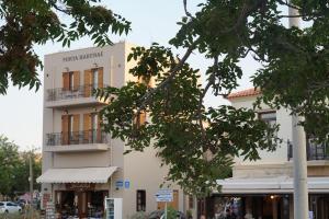 a tall white building with a sign on it at Porta Harenae Residencia in Chania +76 photos