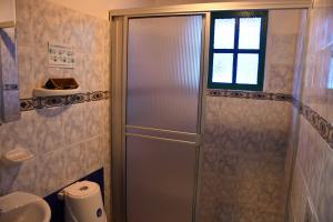 a shower with a glass door in a bathroom at La Cigarra Casa de Huéspedes in Salento +96 photos