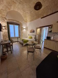 a bedroom with a bed and a table and chairs at Torre Pendio b&b in Corato