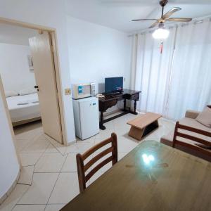 a living room with a table and a desk at Apart Liberdade 4 Pessoas Garagem,Feirinha ,Hakka, Hóspitais in Sao Paulo +45 photos