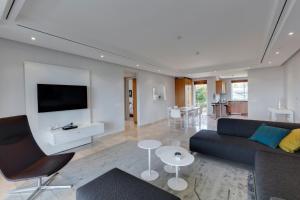 a living room with a couch and a tv at 401 Apartment in Cape Town