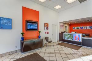 a waiting room at a hospital with a tv on the wall at Motel 6-Portland, OR - Tigard West in Tigard