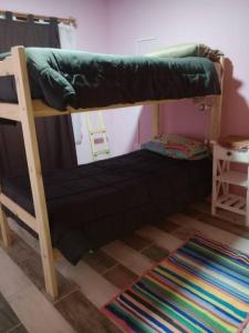 a bunk bed in a room with a rug at Lugar tranquilo para descansar in El Calafate