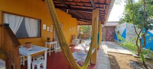 a porch of a house with a hammock in it at Casa Strela Jericoacoara in Jericoacoara
