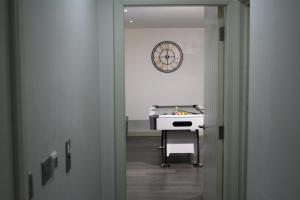 an office with a desk and a clock on the wall at Abode apartments in Bradford
