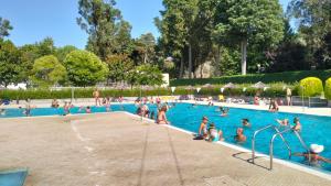 a group of people in a swimming pool at Serra da Estrela - Casa Castro in Gouveia