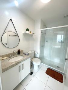 a bathroom with a shower and a toilet and a sink at Loft Barra da Tijuca - Ilha Pura - Rock in Rio, Riocentro in Rio de Janeiro