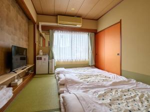 Voodi või voodid majutusasutuse Tabist Hotel Seishokan toas