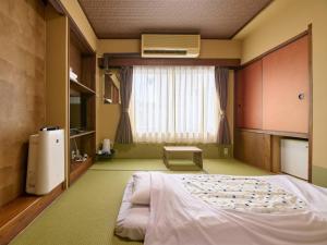 Voodi või voodid majutusasutuse Tabist Hotel Seishokan toas