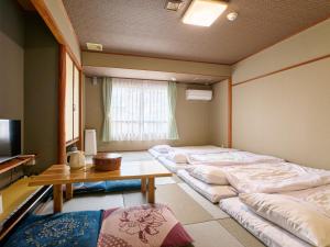 Voodi või voodid majutusasutuse Tabist Hotel Seishokan toas