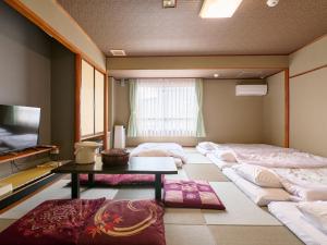 Voodi või voodid majutusasutuse Tabist Hotel Seishokan toas