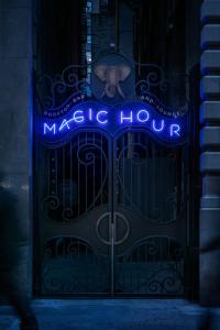 an elephant standing in front of a gate with a magic hour sign at MOXY NYC Times Square in New York