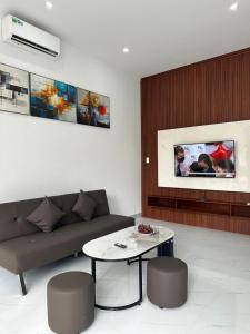 a living room with a couch and a table at Vinh Home Apartment in Quang Tri +21 photos