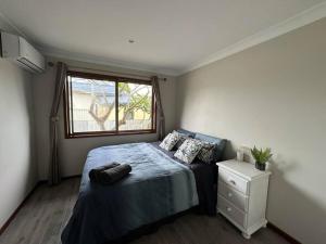 a small bedroom with a bed and a window at Waterfront Wyuna in Tweed Heads