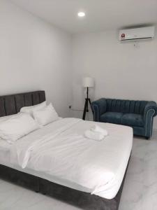 a bedroom with a large bed and a couch at Enap Machang in Macang