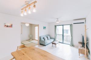 a living room with a couch and a tv at 惠 - Megumi Okinawa in Tokeshi