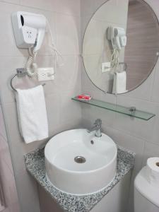 a bathroom with a white sink and a mirror at Pool Breeze 202 in Punta Cana