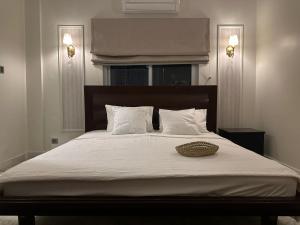 a bedroom with a large bed with white sheets at Oceanfront Oasis - Steps to Dolmen Mall in Karachi