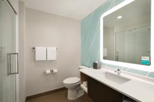 a bathroom with a sink and a toilet and a mirror at avid hotel Nashville - Lebanon an IHG Hotel in Lebanon +37 photos