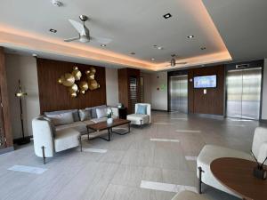 a lobby with a couch and chairs and a table at Style 823 Condo - Style Residences SM City Iloilo in Iloilo City