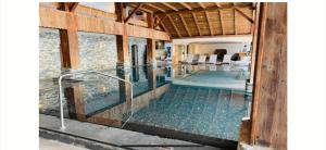 a house with a swimming pool with a glass floor at Appartement central avec Spa in Crans-Montana