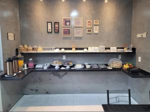 a kitchen with a counter with food on it at Hotel Stillus in Ribas do Rio Pardo