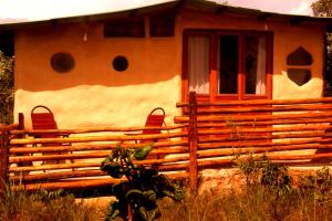 a house with a wooden fence in front of it at BioChalé Buena Vista in Sao Jorge