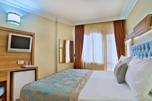 Postel nebo postele na pokoji v ubytování Budo Hotel