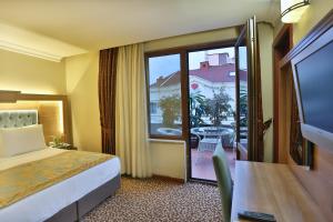 Postel nebo postele na pokoji v ubytování Budo Hotel