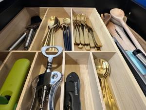 a drawer with utensils in a wooden box at Molo Namai Nida in Neringa