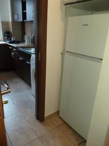 a kitchen with a white refrigerator in a room at Ultracentral free private parking in Ploieşti
