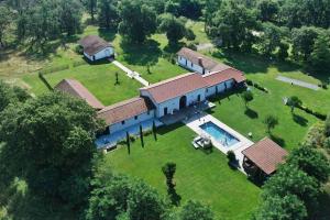an aerial view of a large house with a swimming pool at Domaine de Bouhémy in Solférino