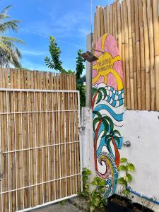 a fence with a painting on the side of it at Precious Homestay -Suite Room in Burgos +5 photos