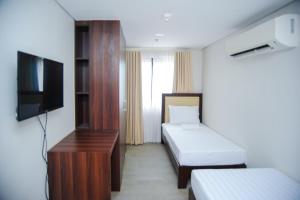 Postel nebo postele na pokoji v ubytování Kaia Isabelle Hotel Puerto Princesa + 20 fotografií