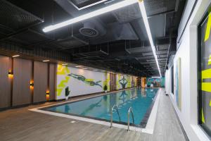 a large swimming pool in a building at Layali Properties - Boho Oasis 3BR Apt - Convention and Exhibition Center in Riyadh