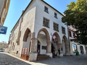 a building on a street with people standing outside at Apartmán Mia in Jihlava