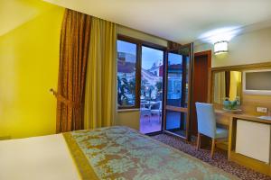 Postel nebo postele na pokoji v ubytování Budo Hotel